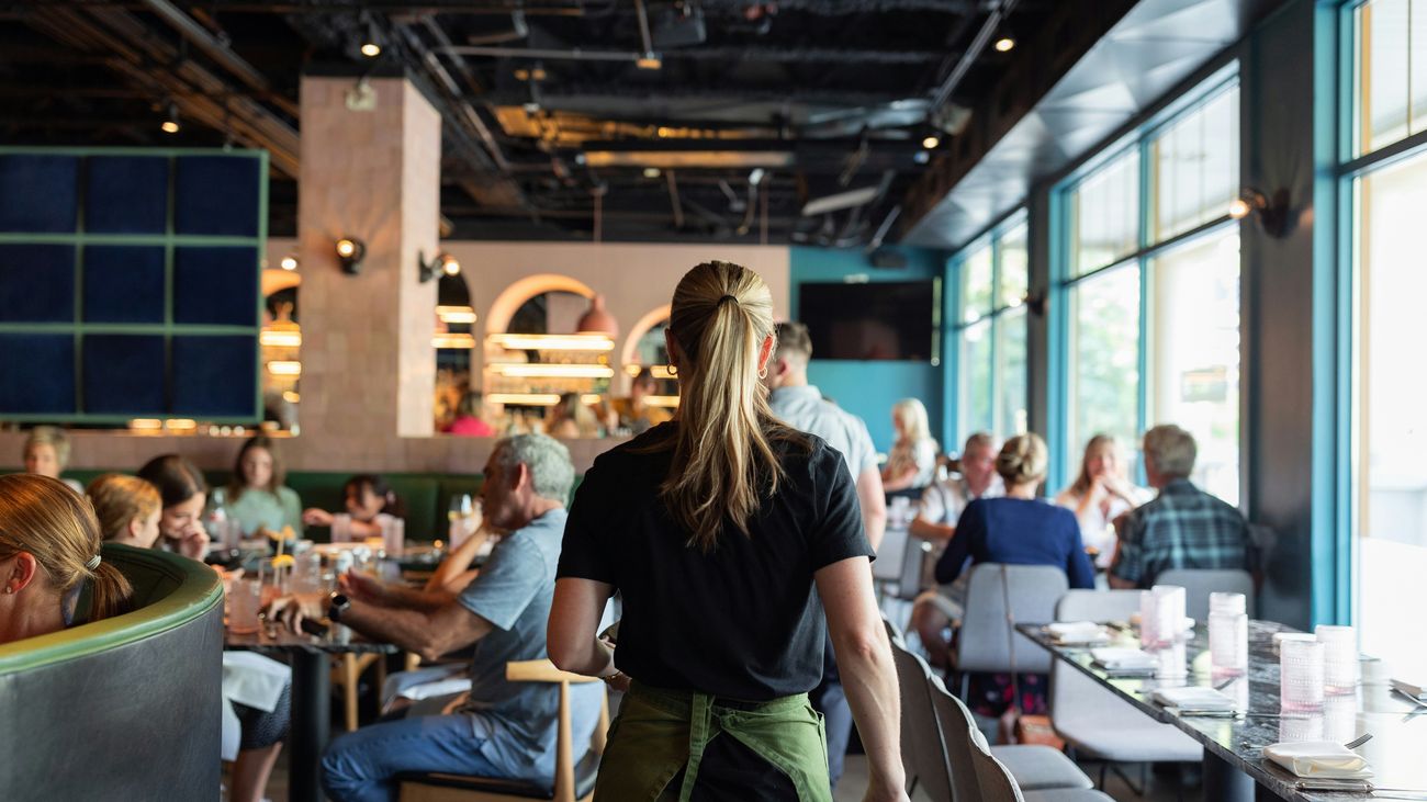 Server working the floor of a busy restaurant