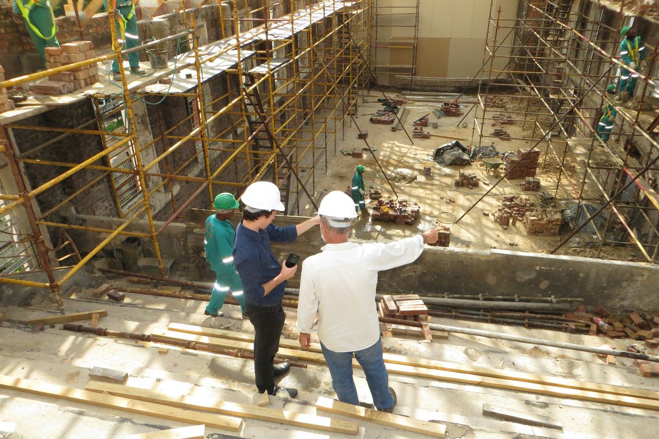 Two supervisors reviewing progress on a small commercial build, the kind of business The Stewart Brokerage places group coverage for
